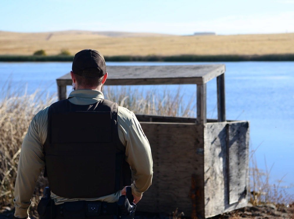Conservation Law Enforcement Officer monitoring activity in a marsh